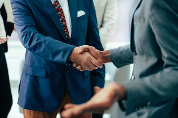 young entrepreneurs shaking hands in the office