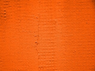 orange background, terracotta texture of uneven painted  wall,  plastered surface