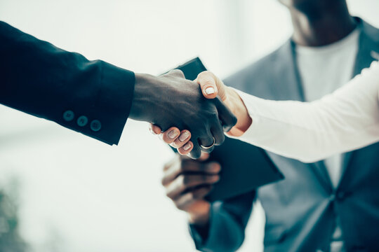 close up. young business partners shaking hands