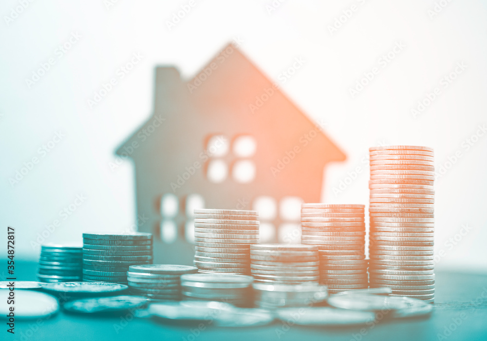Poster double exposure of coins stack and home model with business graph in concept of money save.