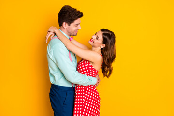 Portrait of positive passionate couple man woman hug embrace cuddle eternal love concept formalwear red dotted dress blue shirt pants isolated over bright shine color background