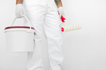 Worker with paint roller and bucket