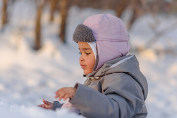 Cute child playing with snow