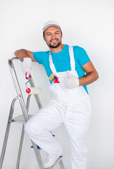 Cheerful man with painting tools showing thumb up