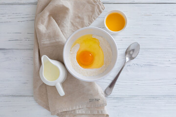 Ingredients for making pancakes, butter, flour, milk, egg, top view