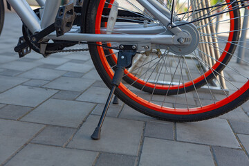 Obraz premium Row of bikes parked for hire, city bikes rent parking, public bicycle sharing system, bike friendly. Sustainable transport.