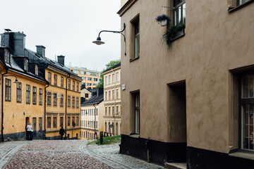Fototapeta na wymiar Picturesque cobblestoned street with colorful houses in Sodermalm in Stockholm