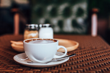 cup of coffee on table in the morning at cafe.