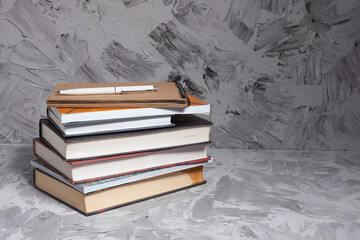 Stack of colorful books. An open book on a stack of books. The concept of education, international...