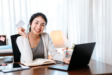 young woman hands holding credit card and using laptop for online shopping. Credit card buy or paymaent conceptl.