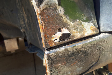 Car with rust on door sill and fender