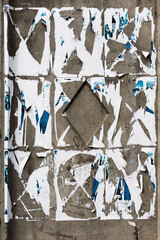 Creative background of rusty metal, painted gray paint carelessly with the remnants of torn paper....