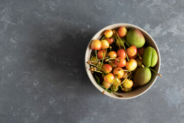 unripe fruits, unripe berries of a cherry on a wooden background, eco product, horizontal orientation, copy space.