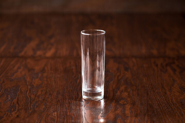 Empty glass highball on the dark wooden table