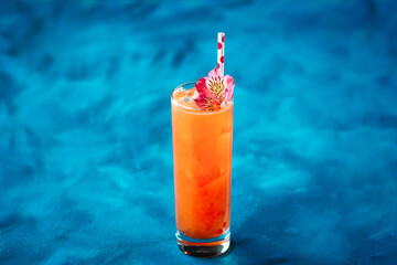 Alcohol fruit cocktail flower straw in highball