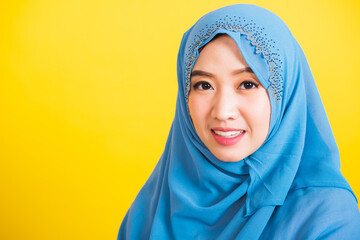 Asian Muslim Arab, Portrait of happy beautiful young woman Islamic religious wear veil hijab she smiling, studio close up shot isolated on yellow background