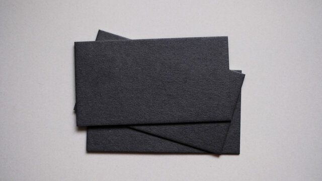 Mockup of two blank business cards stacks at white textured background. © Wanisa