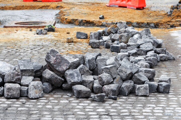 Pieces of rubble lying on the road, there is repair construction work