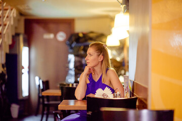 Young stylish beautiful woman walking in street, wearing dress and jacket, fashion outfit, spring and summer trend.