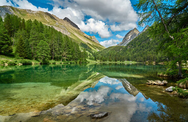 Naklejka na ściany i meble Landscape panorama of Lai da Palpuogna / Palpuognasee, mountain lake, Albula Pass in the municipality of Bergün, in the Grisons, Switzerland 