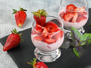 Dessert with fresh strawberry, ricotta, strawberry jam and basil on glasses