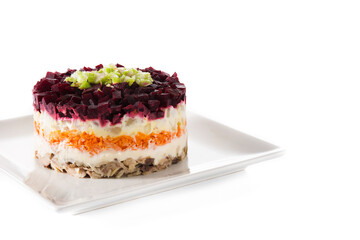 Traditional Russian herring salad with beetroot and carrots isolated on white background. Copy space