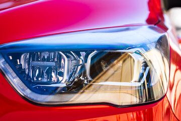 Close up photo of modern car, detail of headlight. Headlight car Projector LED of a modern luxury...
