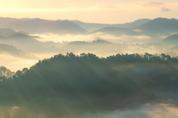 Beautiful Landscape of mountain layer in morning sun ray and winter fog.