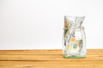 Glass jar full of money. Crisis Savings Concept.