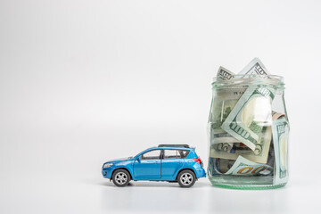 Miniature car model and Financial statement with coins. Finance and car loan, saving money for a...