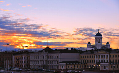 Colorful Panorama Of Embankment In Helsinki with traffic, people and old colorful buildings At Summer Sunset Evening, , Finland. Cityscape View From Sea