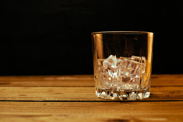 Glass of cold pale beer placed on a rustic wooden table