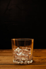 Glass of cold pale beer placed on a rustic wooden table