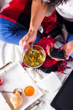 The Young Woman On The Couch And With Sage Tea On The Hand.