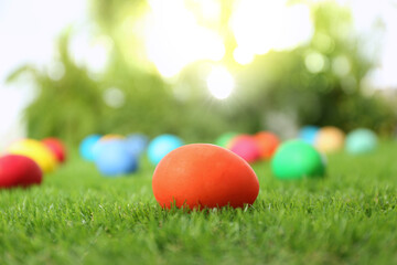 Fototapeta na wymiar Colorful Easter eggs on green grass outdoors