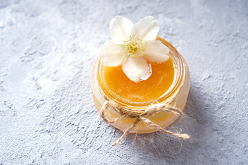 Natural honey with flower in a glass jar