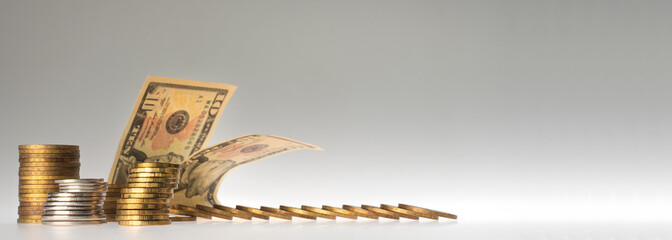 finance. stacks of coins and paper bills on a gray background