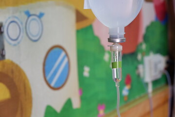 Asian child boy is on drip receiving a saline solution.
