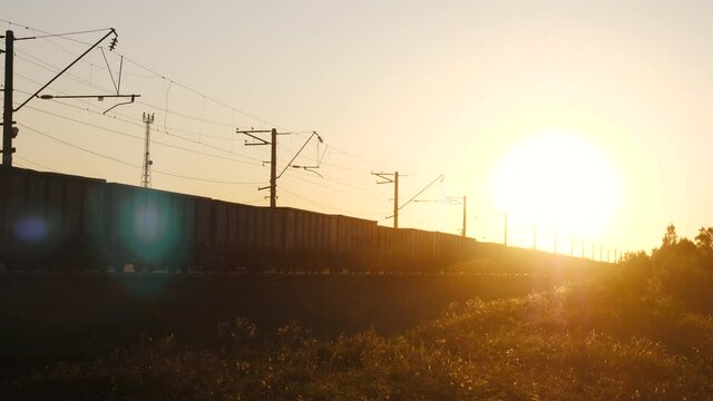 Freight train moves, carry containers, delivers wagon row with cargo. Industrial transportation of goods, heavy business transit, merchandise commercial delivery.
