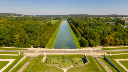 Aerial view of medieval landmark royal hunting castle Fontainbleau near Paris in France and lake with white swans