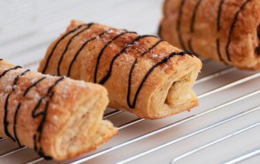 Closeup of a homemade chocolate napolitana on a oven plate.