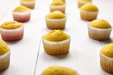 Cupcakes on white background. Muffins on wooden table, closeup. Homemade bakery