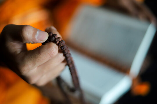 hand holding a rosary