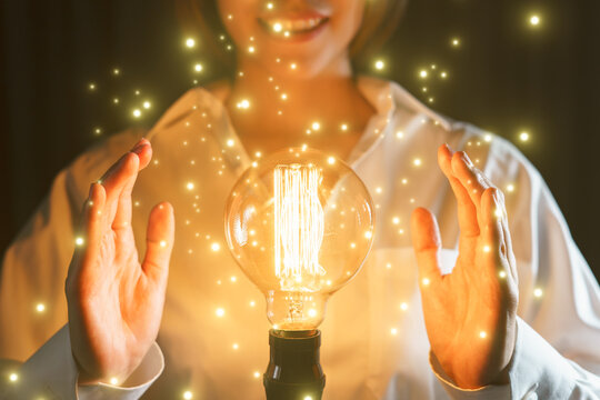 Lightbulb between two hands as a symbol of ideas.