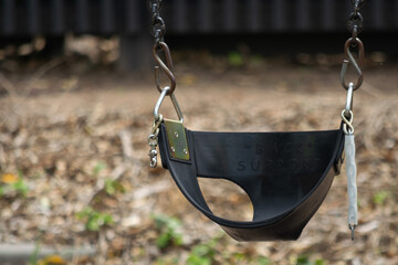 Empty toddler or baby swing at a playground.