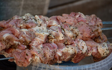  juicy pickled meat strung on skewers, raw barbecue, picnic with friends