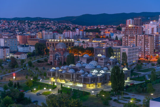 Sunset view of the National library of Kosovo and unfinished serbian orthodox church of Christ the Saviour in Prishtina, Kosovo
