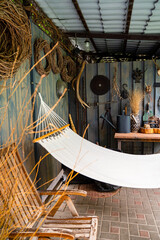 hammock hanging on wooden deck in backyard. place to relax in fresh air.