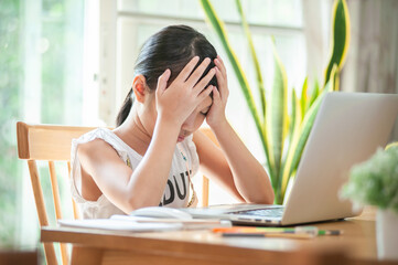 little girl using computer at home for Homeschool distancing and Do not understand online lessons Stay home to learning online concept