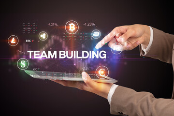 Close-up of a touchscreen with TEAM BUILDING inscription, business opportunity concept